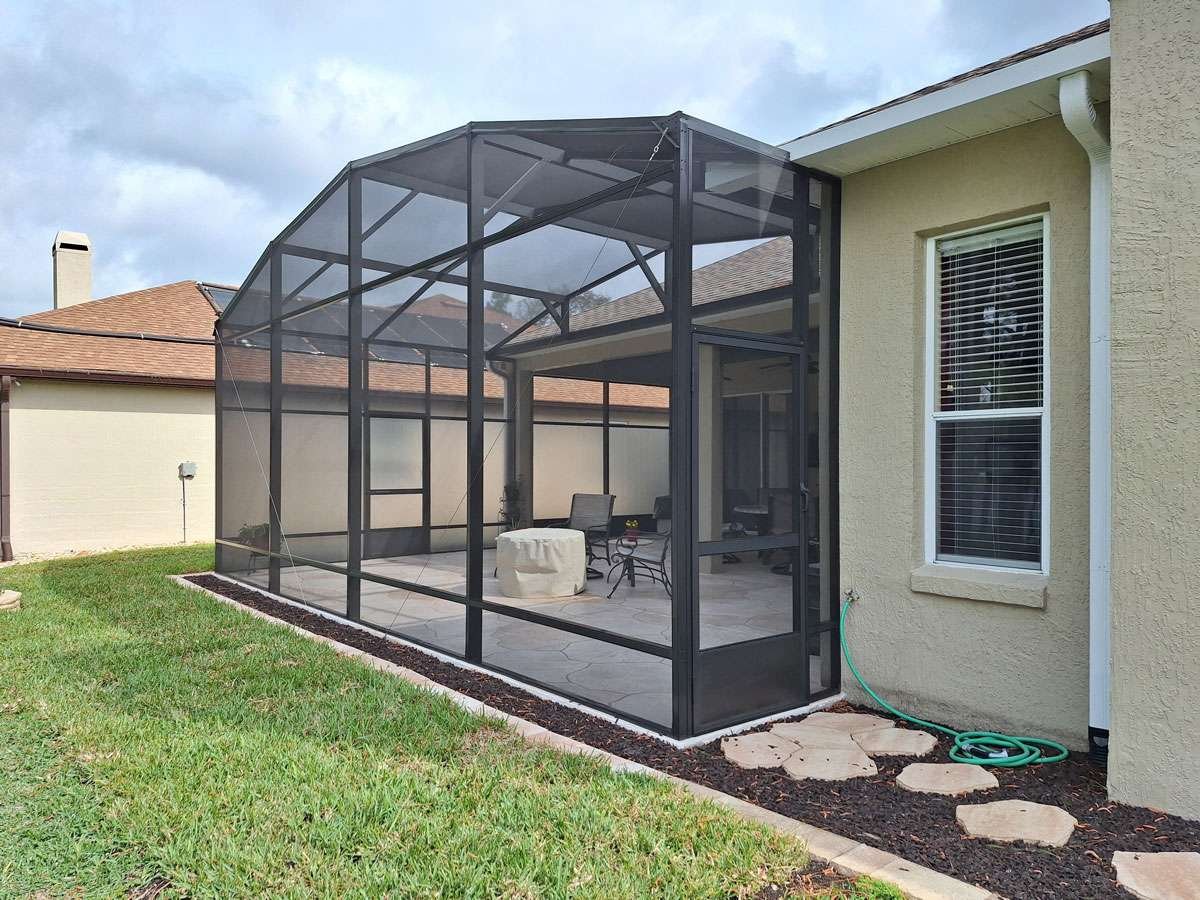 Residential lanai screen enclosure installation in Palm Coast, FL backyard